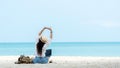 Lifestyle freelance woman raise arms relax after using laptop working on the beach. Royalty Free Stock Photo